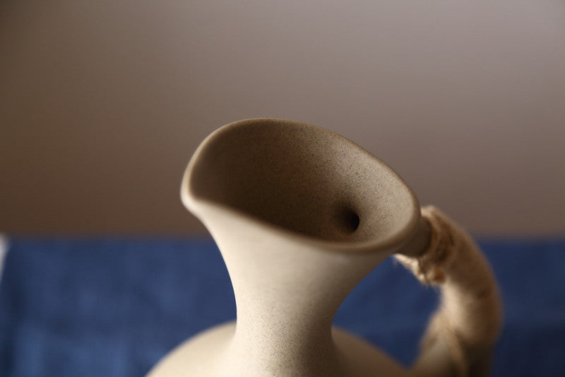 Pottery kettle set detail shot - rope handle and spout close up