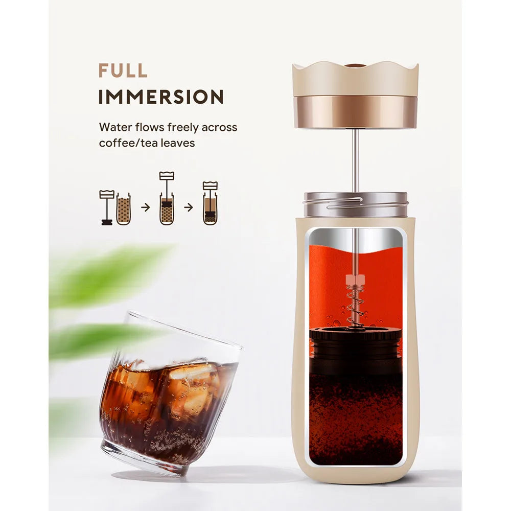 Full immersion coffee or tea maker with a glass of iced coffee on a white background