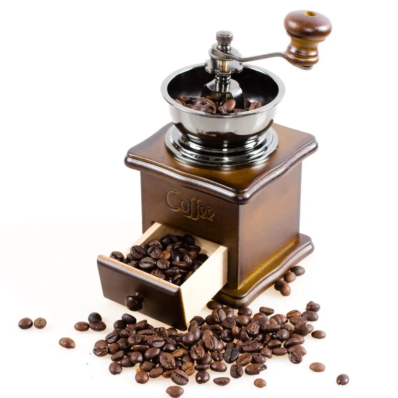 Manual coffee grinder with coffee beans on a white background