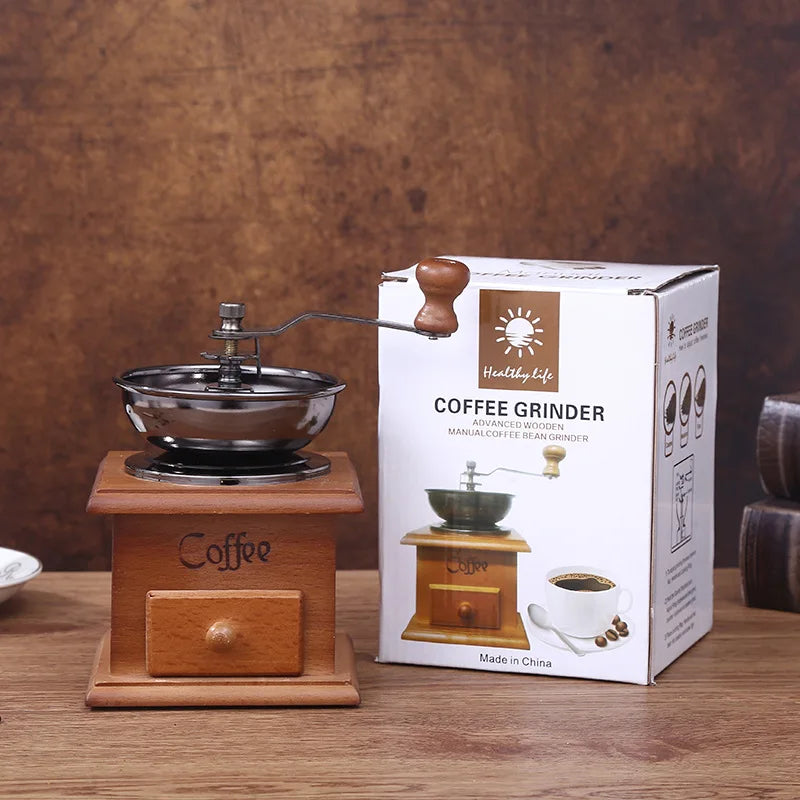 Wooden coffee grinder and its packaging on a wooden surface with a brown background